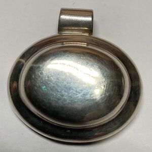 ATI Mexico Sterling Silver Oval Shaped Pendant. 1 3/8 inch by 1 3/8 inches